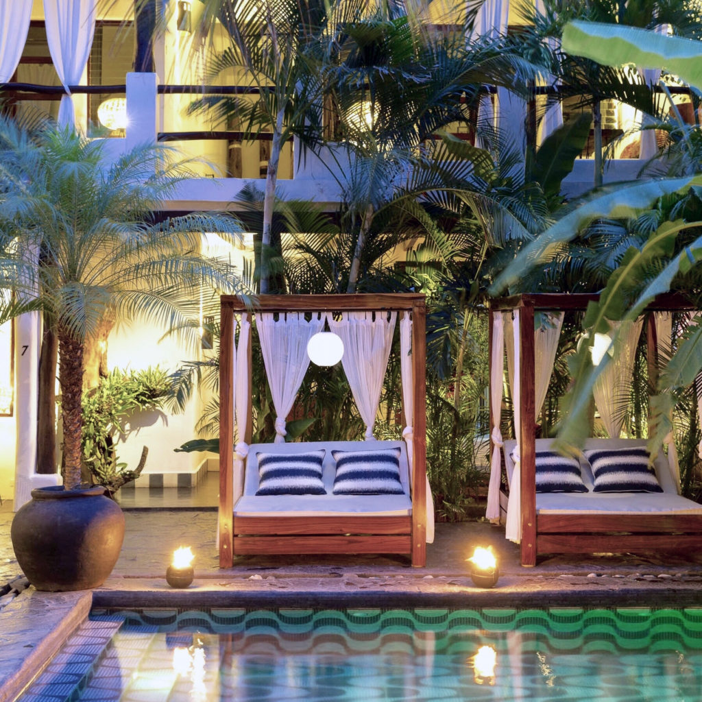 poolside cabana bedsand palm trees at tribal hotel in granada, nicaragua